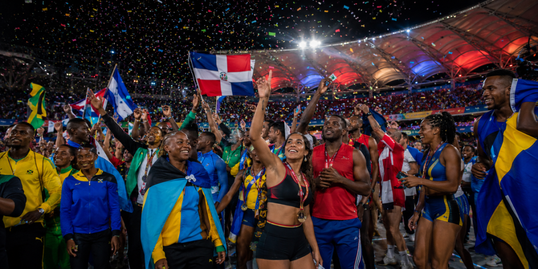 Caribbean and Central American athletes celebrating at a stadium closing ceremony